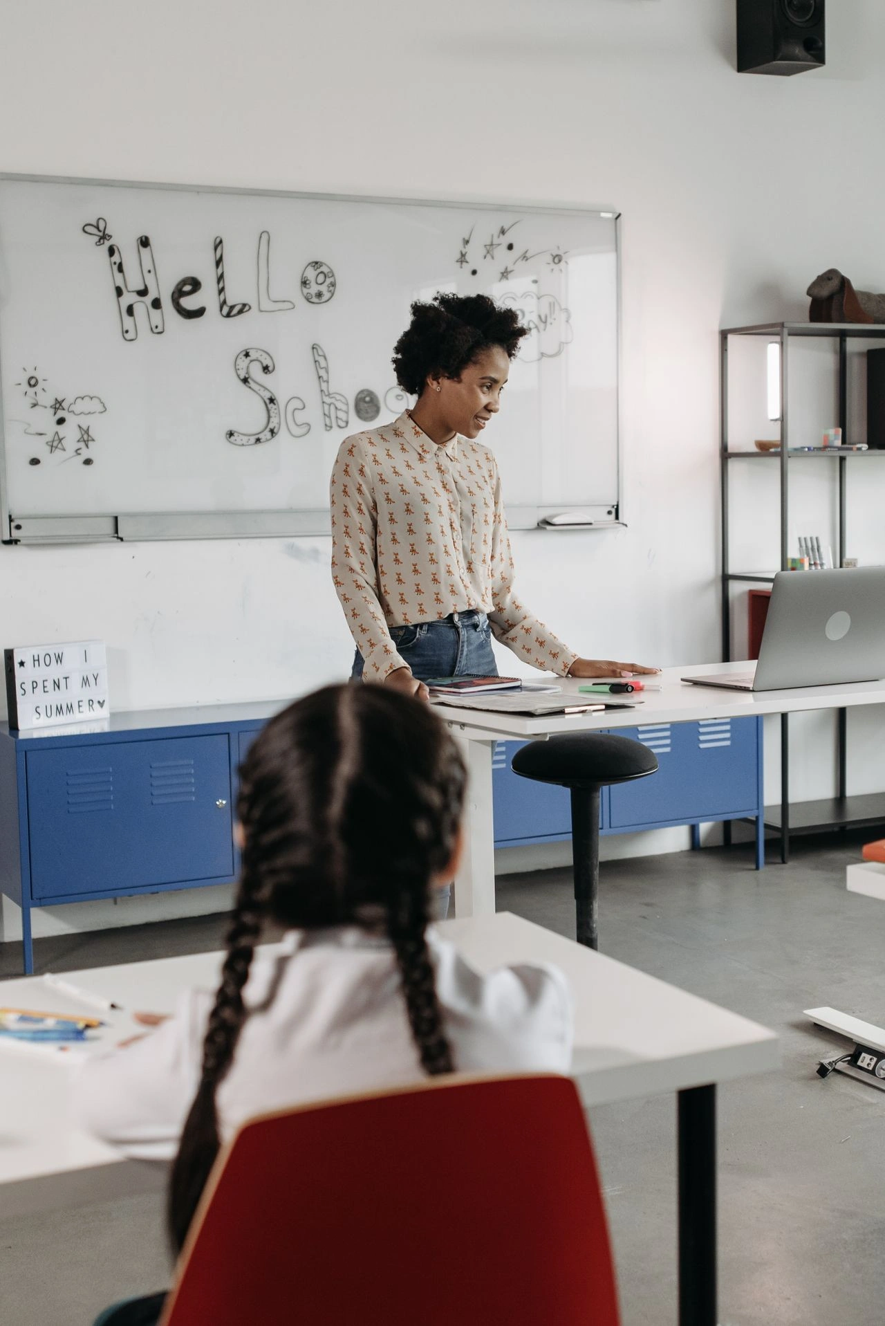 Illustration of a teacher helping a student write